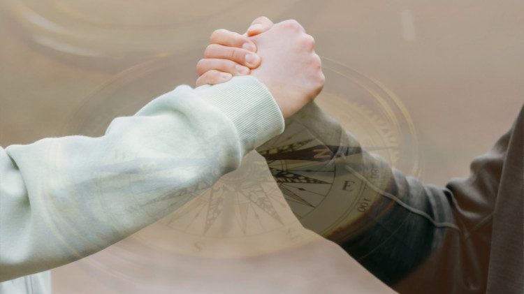Grasping each other arms to show trust and support